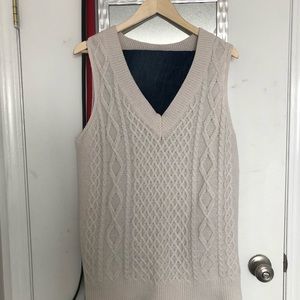 Cream sweater vest.